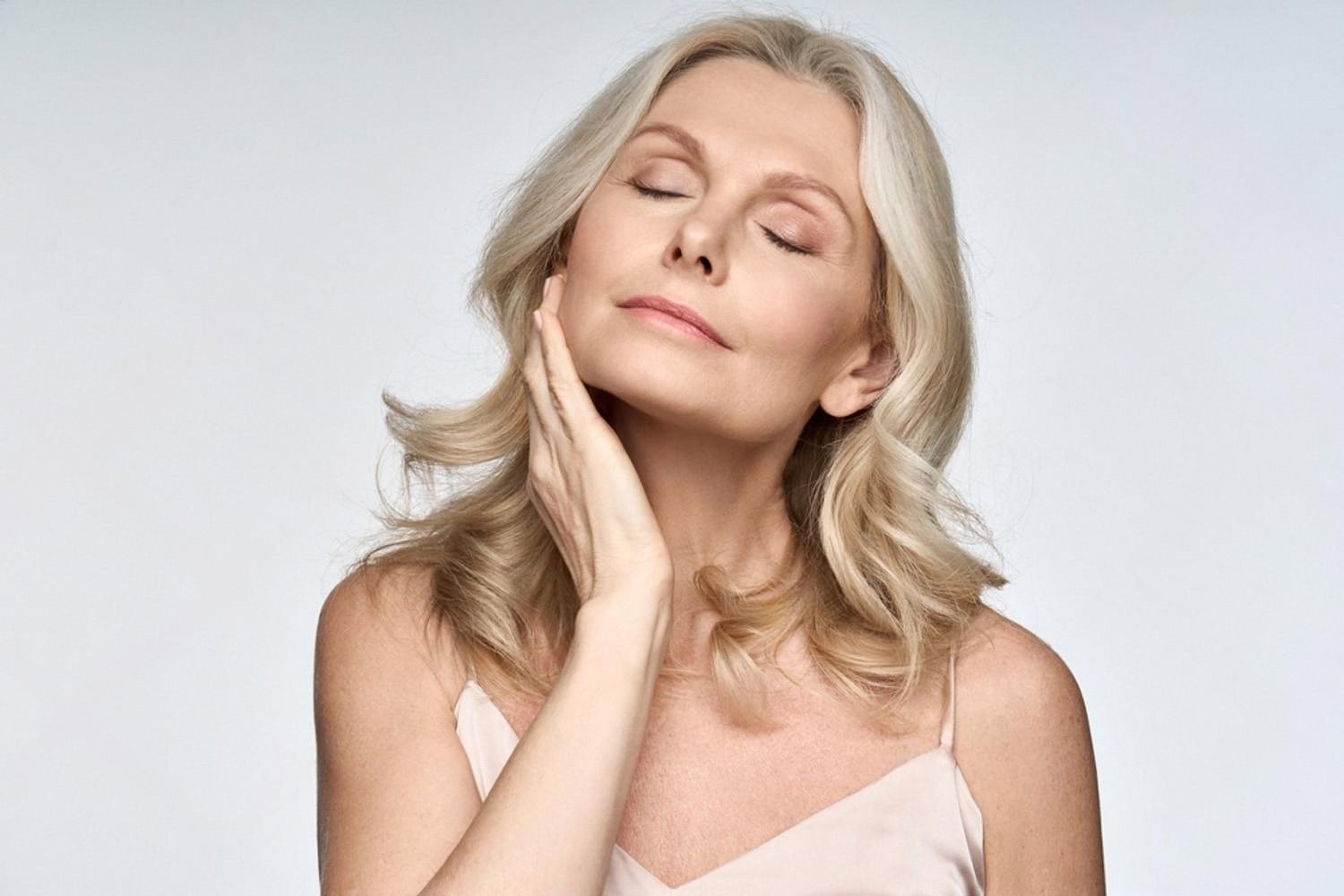 Mature woman with glowing lifted skin after hardware facial procedures in a UAE clinic